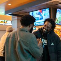 Two event guests standing together and talking
